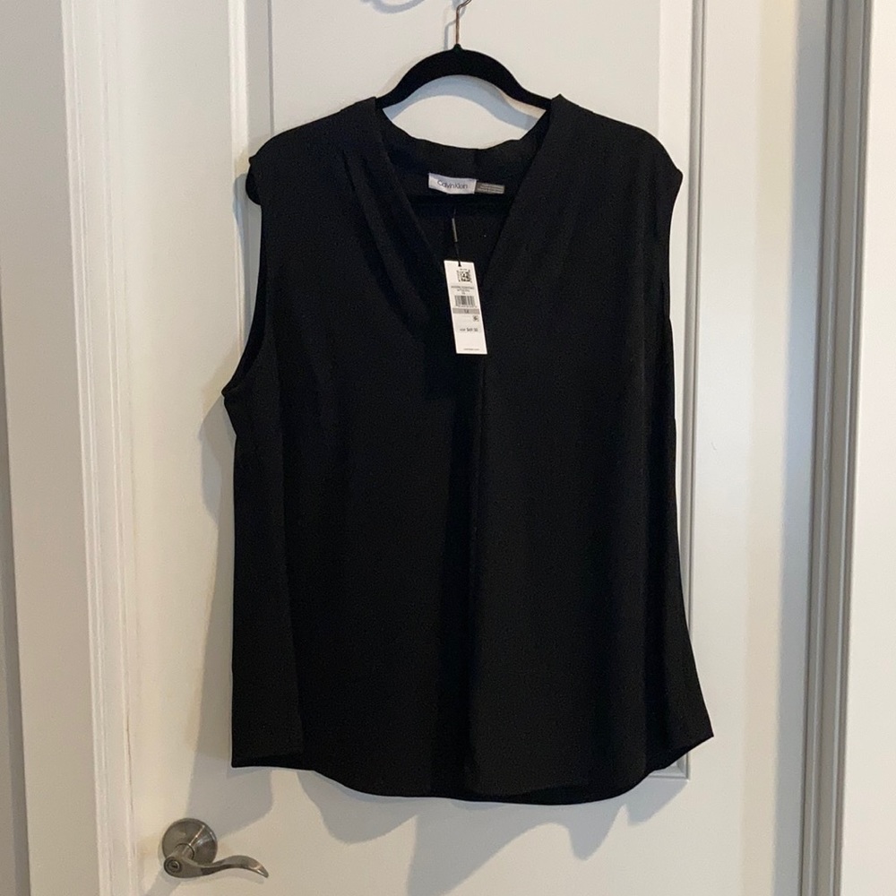 Rich black sleeveless blouse.